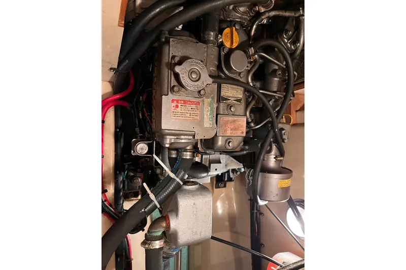 Slide: The Image of Engine compartment of a 2000 Island Packet 350 sailboat, showcasing mechanical components and wiring. - 26