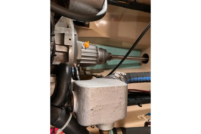 Slide: The Image of Engine compartment of a 2000 Island Packet 350 sailboat, showcasing mechanical components. - 27