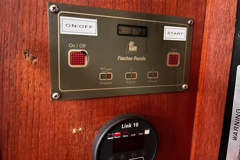 Slide: The Image of Fischer Panda control panel on 2000 Island Packet 350 sailboat, featuring on/off and start buttons. - 29
