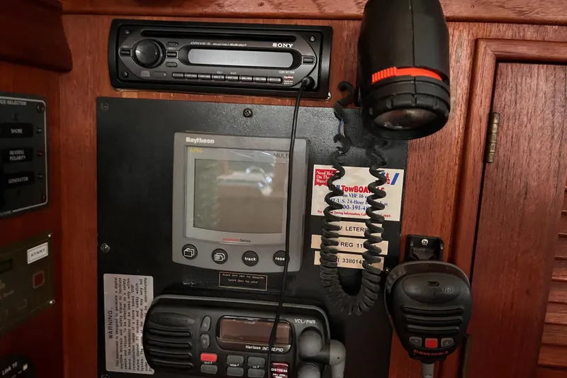 Slide: The Image of Control panel of a 2000 Island Packet 350 sailboat with navigation and communication equipment. - 30