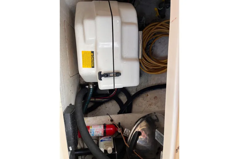Slide: The Image of Storage compartment of a 2000 Island Packet 350 sailboat with equipment and cables. - 32