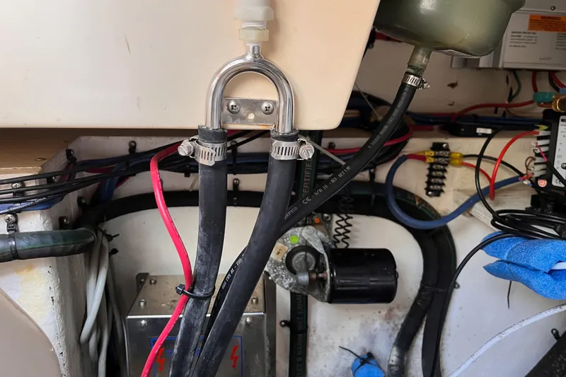 Slide: The Image of Engine compartment of a 2000 Island Packet 350 sailboat, showing hoses and wiring. - 35