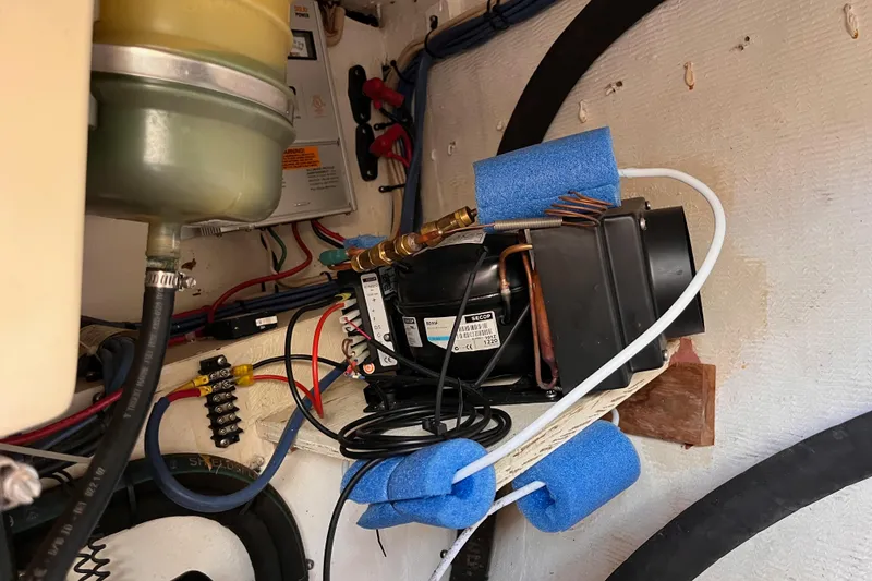 Slide: The Image of Engine compartment of a 2000 Island Packet 350 sailboat with visible wiring and components. - 38