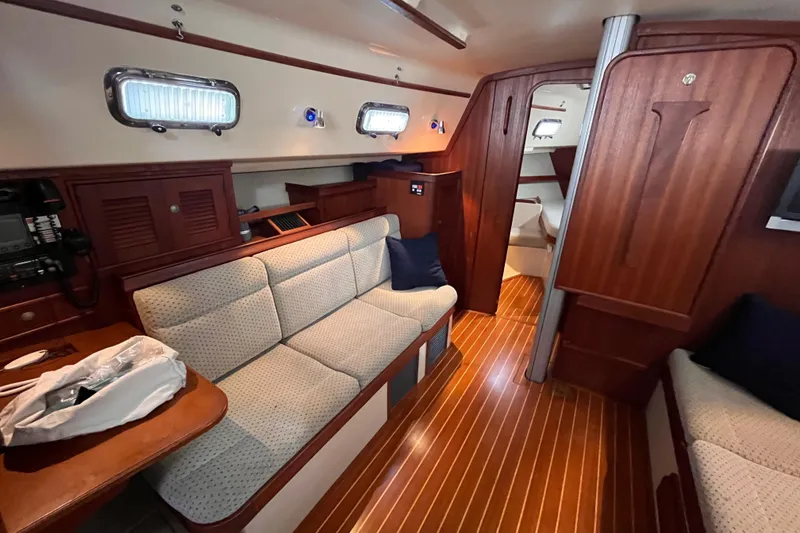 Slide: The Image of Interior of 2000 Island Packet 350 sailboat with cozy seating and wooden finishes. - 7