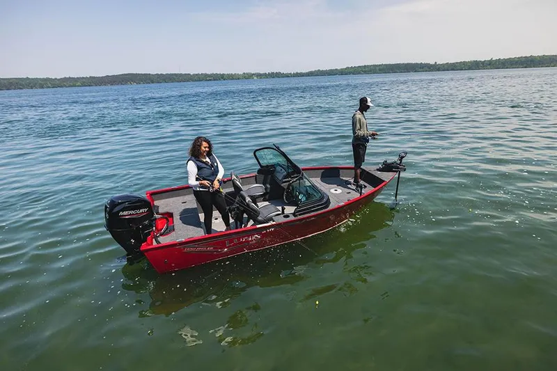 The Image of 2025 Lund 1650 Angler Sport boat with cover on trailer in parking lot. - 0