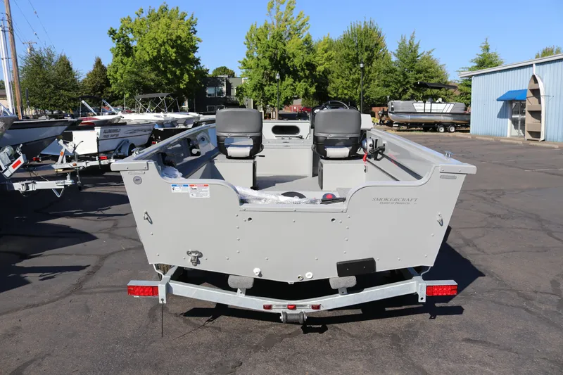 Slide: The Image of 2025 Smoker Craft Pro Lodge 160 boat on trailer, parked outdoors. - 2