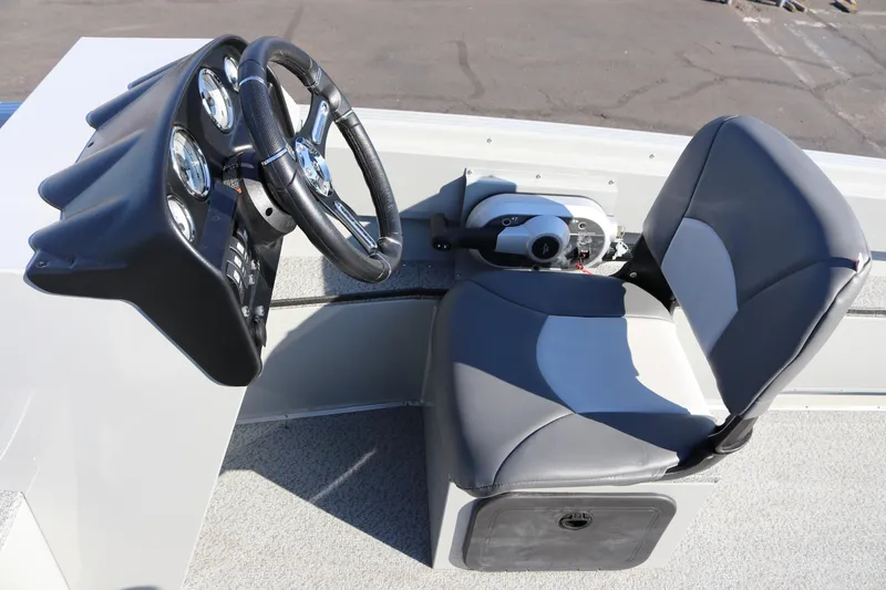 Slide: The Image of 2025 Smoker Craft Pro Lodge 160 boat cockpit with steering wheel and seat. - 5