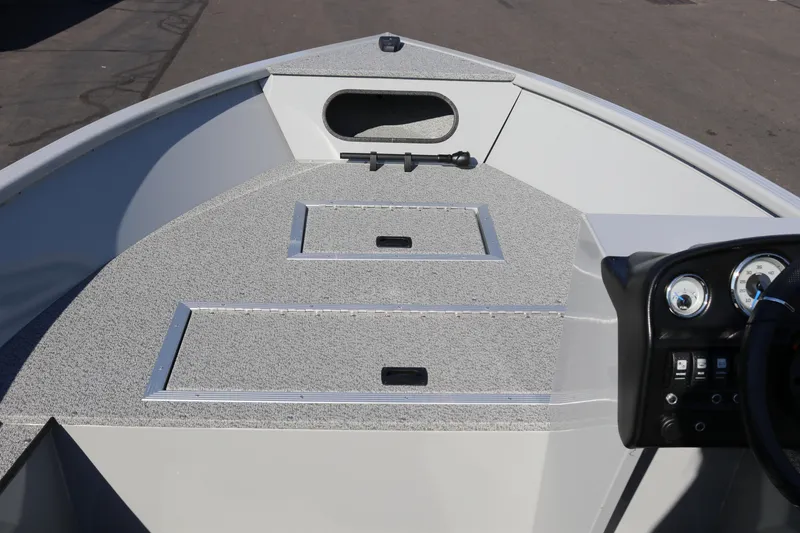 Slide: The Image of 2025 Smoker Craft Pro Lodge 160 boat interior with dashboard and storage compartments. - 7