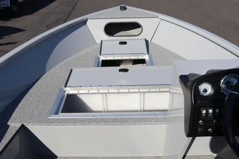 Slide: The Image of 2025 Smoker Craft Pro Lodge 160 boat interior with storage compartments and control panel. - 9