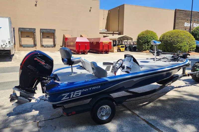 Slide: The Image of 2025 Nitro Z18 Pro boat with powerful engine, parked outdoors near loading docks. - 2