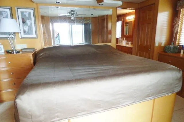Slide: The Image of Luxurious bedroom in 2007 Starlite 18x85 houseboat with mirrored closet and wooden furnishings. - 11
