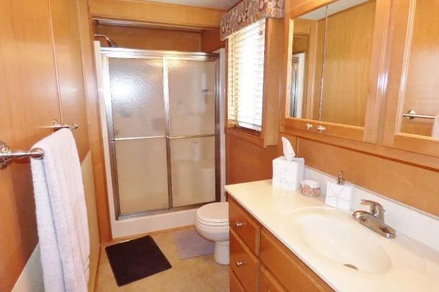 Slide: The Image of Modern bathroom in 2007 Starlite 18x85 houseboat with shower and wooden cabinetry. - 12