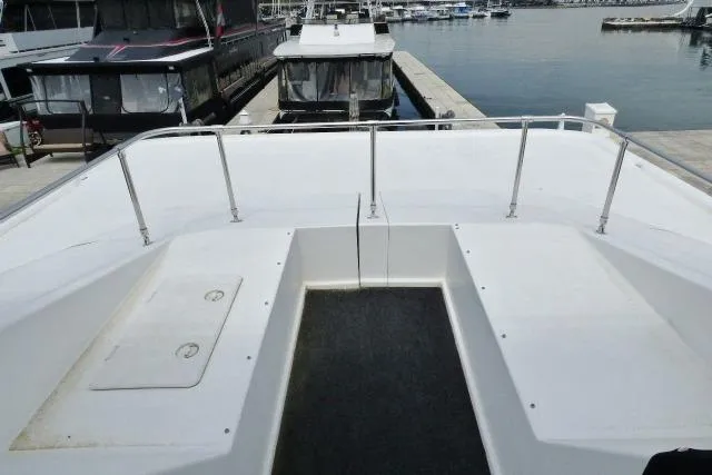 Slide: The Image of Front deck of a 2007 Starlite 18x85 houseboat docked at a marina. - 14