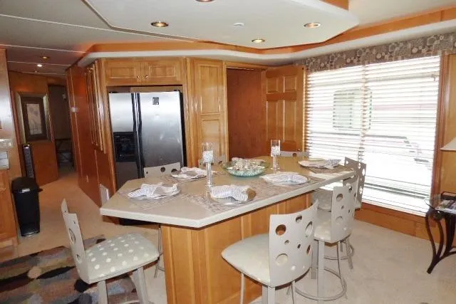 Slide: The Image of Modern kitchen interior in 2007 Starlite 18x85 houseboat with island seating and stainless steel appliances. - 5