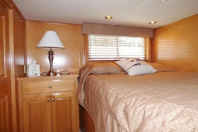 Slide: The Image of Cozy bedroom in 2007 Starlite 18x85 houseboat with wooden cabinetry and soft lighting. - 8