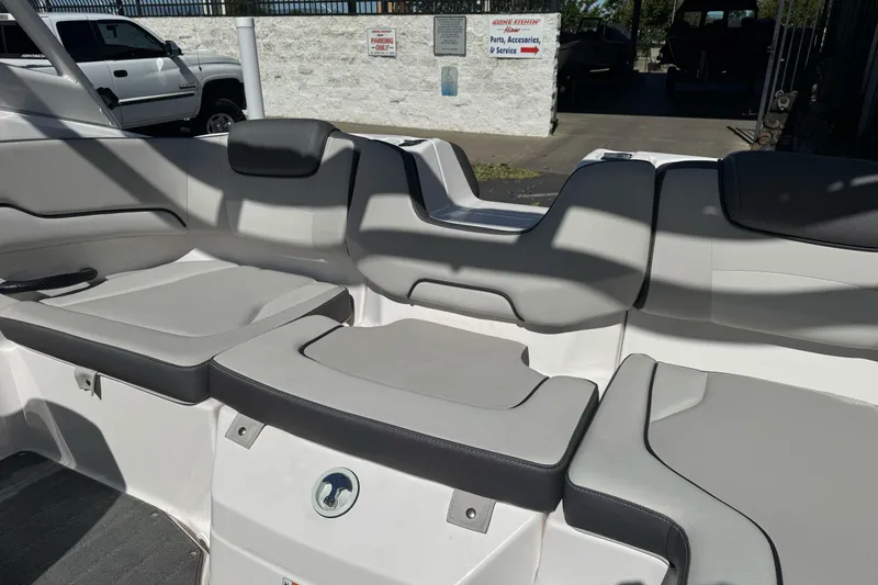 Slide: The Image of 2024 Yamaha Boats AR190 interior seating with gray upholstery and modern design. - 15