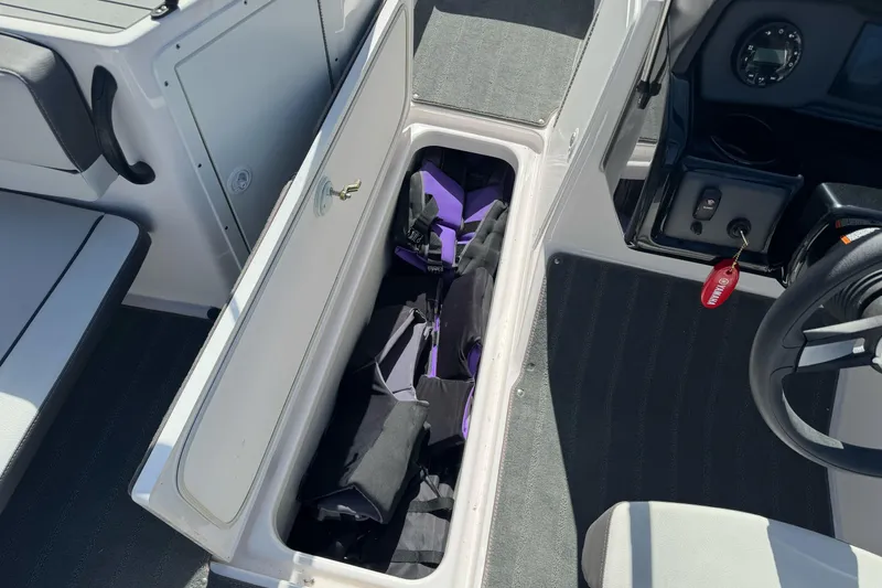 Slide: The Image of 2024 Yamaha AR190 boat interior storage compartment with life jackets. - 19