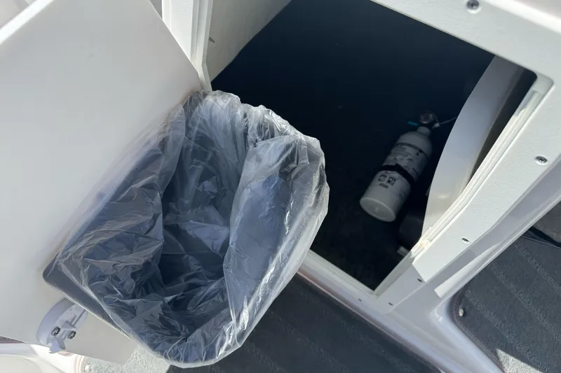 Slide: The Image of Trash bin and fire extinguisher storage on 2024 Yamaha AR190 boat. - 22