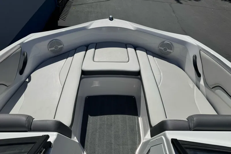 Slide: The Image of 2024 Yamaha Boats AR190 bow seating area with speakers and cushioned seats. - 23