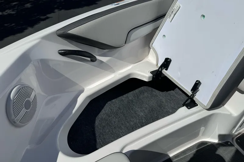 Slide: The Image of 2024 Yamaha Boats AR190 interior seating with storage compartment and speaker. - 26