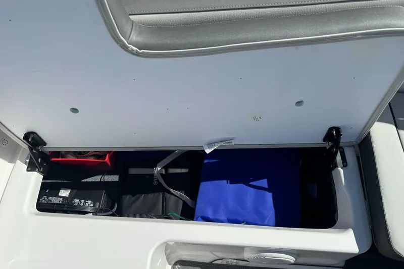 Slide: The Image of Open storage compartment in 2024 Yamaha AR190 boat, showing interior contents. - 29