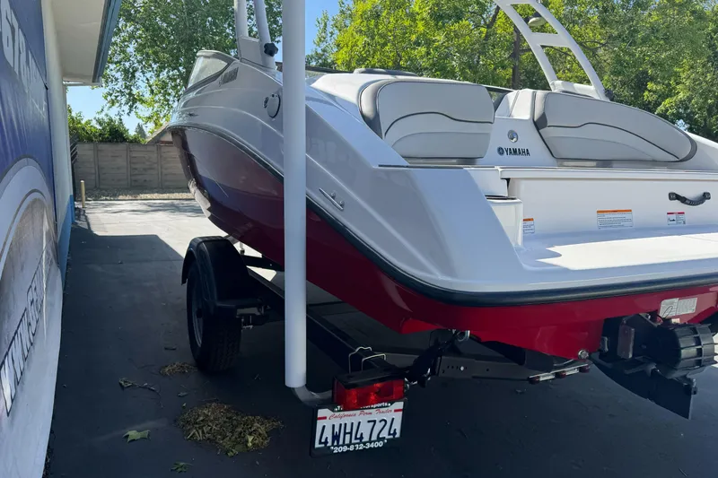 Slide: The Image of 2024 Yamaha Boats AR190 on trailer, parked outdoors, showcasing sleek design and vibrant colors. - 5