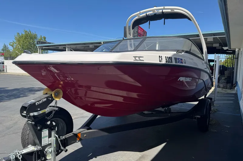 Slide: The Image of 2024 Yamaha Boats AR190 on trailer, red hull, parked outdoors. - 6