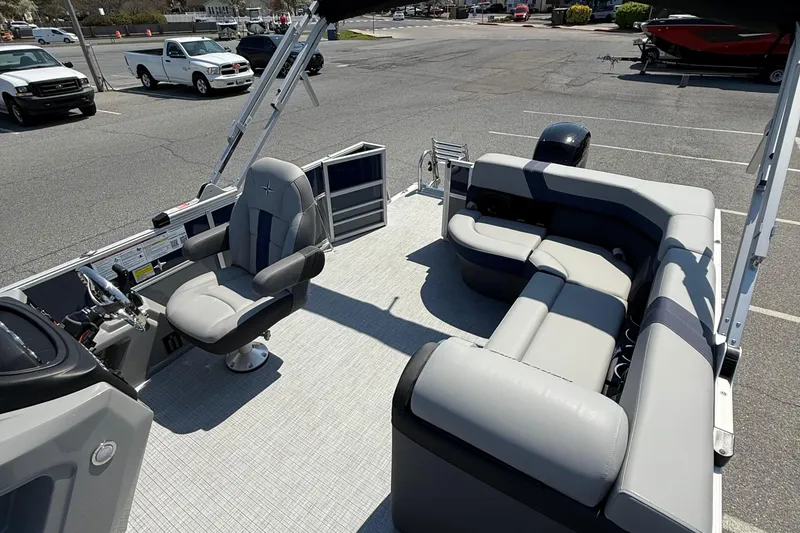 Slide: The Image of 2026 Berkshire 22CL2 CTS pontoon boat interior with plush seating and steering console. - 10
