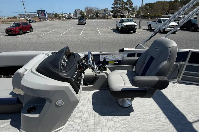 Slide: The Image of 2026 Berkshire 22CL2 CTS boat interior with captain's chair and control panel in a parking lot. - 13