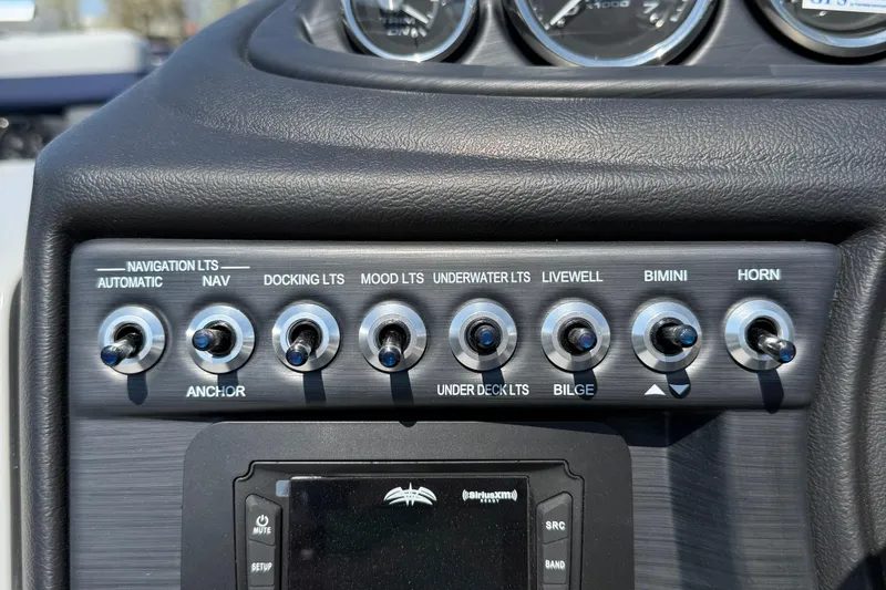 Slide: The Image of Control panel of 2026 Berkshire 22CL2 CTS boat with various switches and gauges. - 15