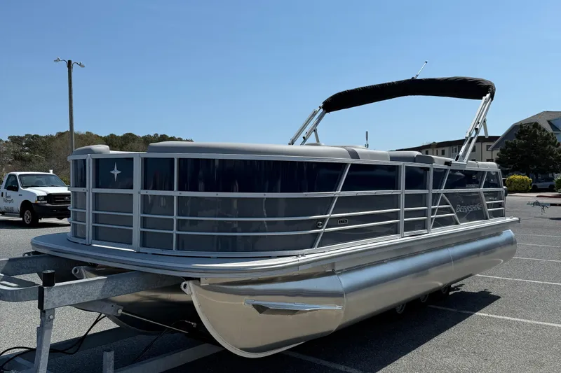 Slide: The Image of 2026 Berkshire 22CL2 CTS pontoon boat parked on a trailer in a sunny lot. - 4