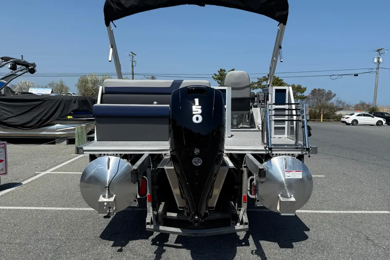 Slide: The Image of 2026 Berkshire 22CL2 CTS pontoon boat with 150 HP engine, parked outdoors. - 7