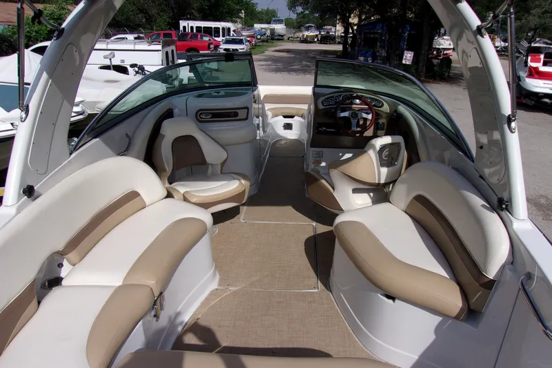 Slide: The Image of 2013 Crownline Eclipse E6 boat interior with beige seating and steering console. - 5