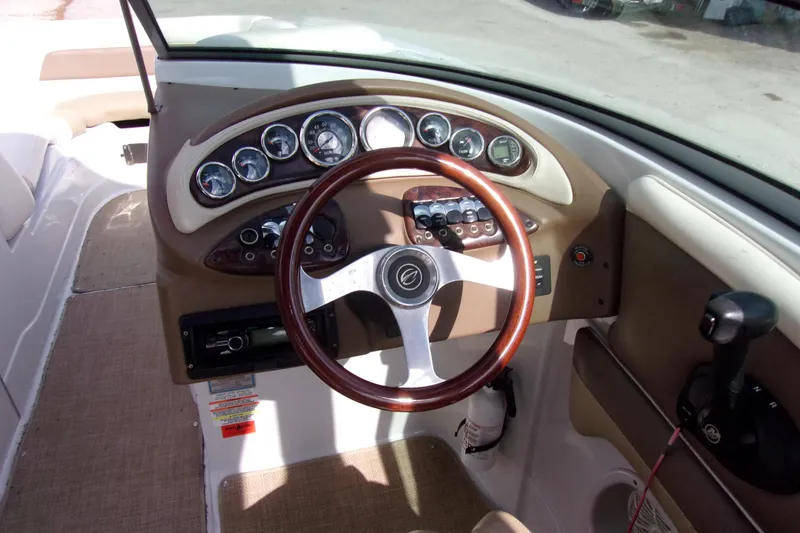Slide: The Image of 2013 Crownline Eclipse E6 boat dashboard with steering wheel and instrument panel. - 6