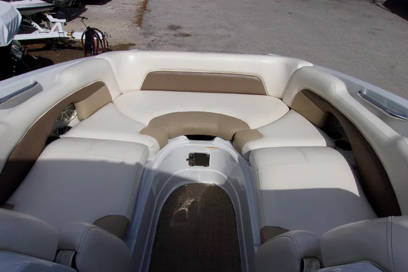 Slide: The Image of 2013 Crownline Eclipse E6 boat interior with beige and white seating arrangement. - 9