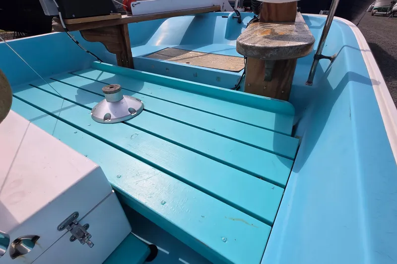 Slide: The Image of 1972 Boston Whaler 17 Montauk interior with turquoise deck and wooden elements. - 12