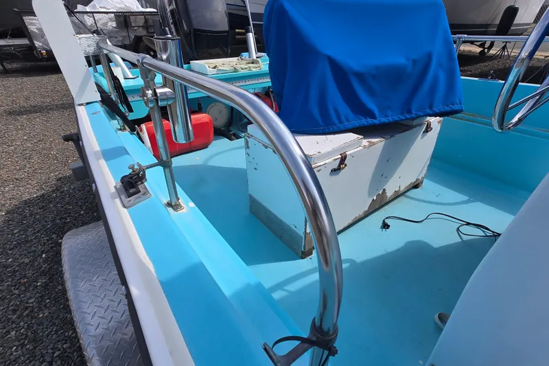 Slide: The Image of 1972 Boston Whaler 17 Montauk boat interior with blue seating and metal railings. - 13