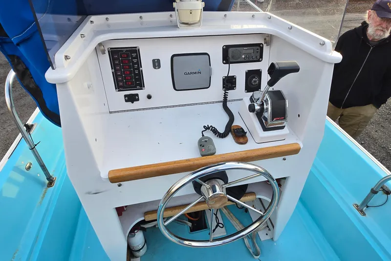 Slide: The Image of 1972 Boston Whaler 17 Montauk boat console with steering wheel and controls. - 2