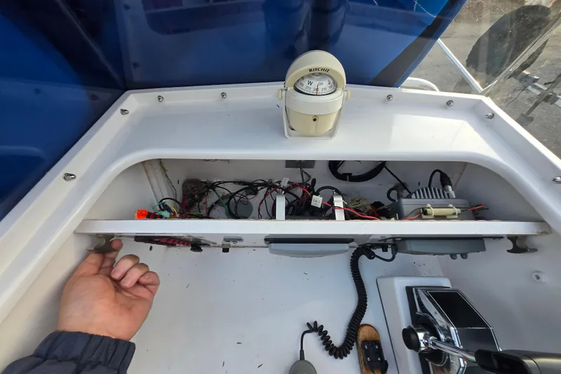 Slide: The Image of 1972 Boston Whaler 17 Montauk dashboard with compass and wiring exposed. - 21