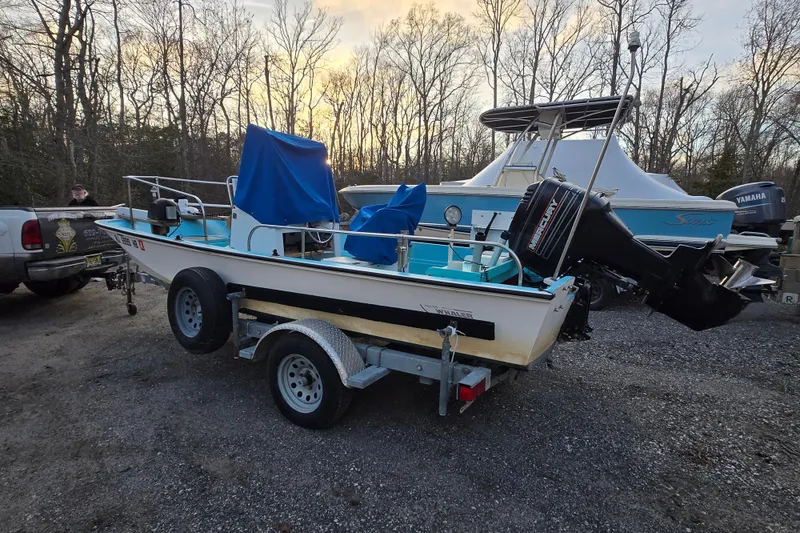 Slide: The Image of 1972 Boston Whaler 17 Montauk boat on trailer, parked outdoors at sunset. - 23