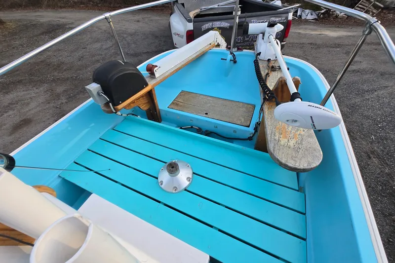 Slide: The Image of 1972 Boston Whaler 17 Montauk boat interior with blue deck and motor. - 3