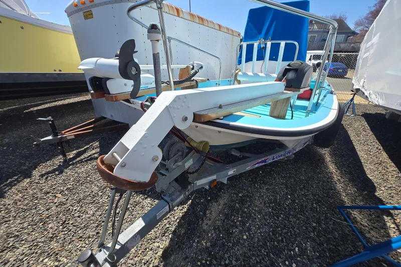 Slide: The Image of 1972 Boston Whaler 17 Montauk boat on trailer, parked outdoors. - 5