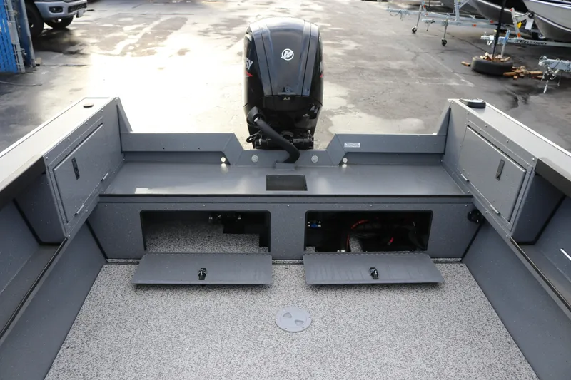 Slide: The Image of 2026 Alumaweld Adventurer 18 boat interior with storage compartments and outboard motor. - 14