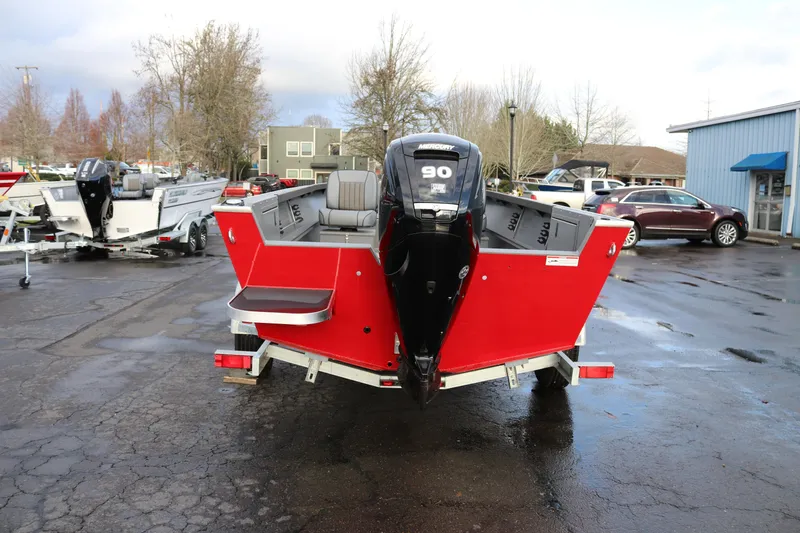 Slide: The Image of 2026 Alumaweld Adventurer 18 boat with Mercury 90 engine, parked outdoors. - 2