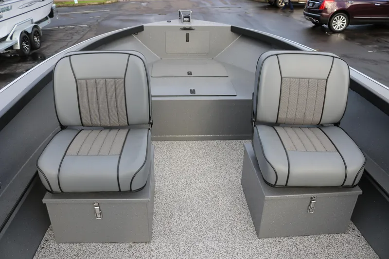 Slide: The Image of 2026 Alumaweld Adventurer 18 boat interior with two gray cushioned seats and storage compartments. - 3