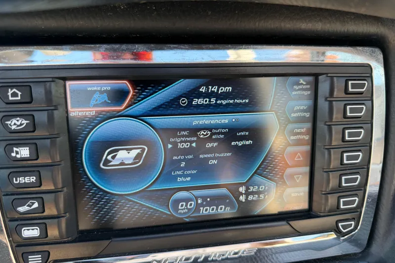 Slide: The Image of Touchscreen display of a 2015 Nautique Super Air Nautique 230 boat showing settings and engine hours. - 12