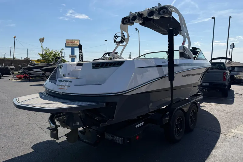 Slide: The Image of 2015 Nautique Super Air Nautique 230 boat on trailer in parking lot. - 3