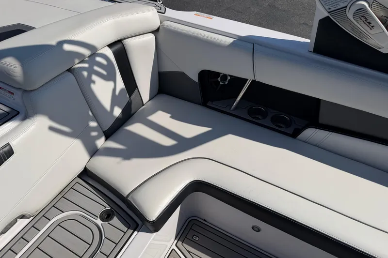 Slide: The Image of 2015 Nautique Super Air Nautique 230 interior seating with cup holders and sleek design. - 8