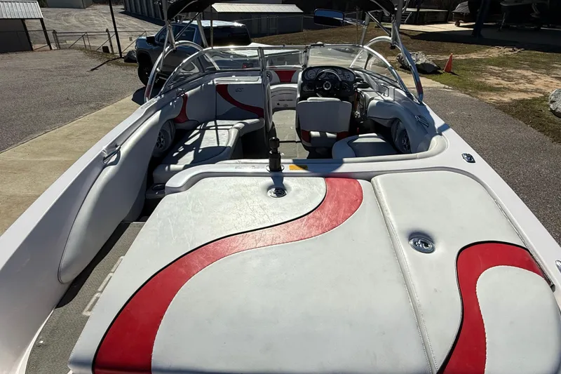 Slide: The Image of 2004 Nautique Air Nautique 226 boat interior with red and white seating and dashboard. - 10