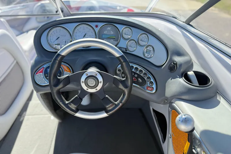 Slide: The Image of 2004 Nautique Air Nautique 226 dashboard with steering wheel and instrument panel. - 15